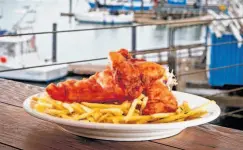  ?? John Storey / Special to the Chronicle ?? Mission Rock Resort’s seafood-focused menu includes fish and chips, best enjoyed sitting near the dock of the bay.