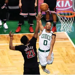  ?? (Reuters) ?? BOSTON CELTICS guard Avery Bradley goes to the hoop past Chicago Bulls forward Jimmy Butler for two of his 24 points in the Celtics’ 108-97 home victory on Wednesday night’s Game 5 of the Eastern Conference first-round series, which Boston now leads 3-2.