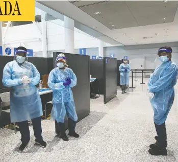  ?? NATHAN DENETTE / THE CANADIAN PRESS ?? Health-care workers wait at COVID-19 testing stations at Pearson Internatio­nal Airport in Toronto on Wednesday.
Beginning Thursday, all internatio­nal passengers over the age of five must take a PCR test upon arrival.