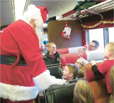  ?? HOOSIER VALLEY RAILROAD MUSEUM ?? Santa visits with guests aboard the Santa Train at the Hoosier Valley Railroad Museum in North Judson.