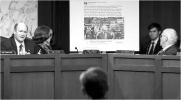  ??  ?? With a Facebook event page featuring a ‘Miners For Trump’ rally created by Russian operatives displayed behind him, Sen. Chris Coons (D-DE) questions witnesses during a Senate Judiciary Subcommitt­ee on Crime and Terrorism hearing titled ‘Extremist...