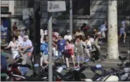  ?? PHOTOS BY ORIOL DURAN — THE ASSOCIATED PRESS ?? People flee the scene in Barcelona, Spain, Thursday after a white van jumped the sidewalk in the historic Las Ramblas district, crashing into a summer crowd of residents and tourists and injuring several people, police said.