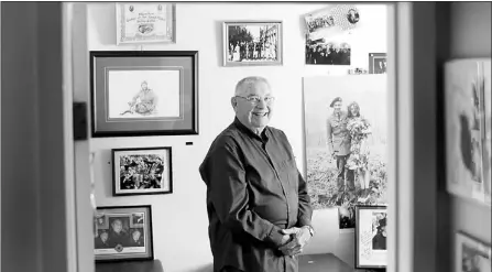  ?? — Photo by The Canadian Press ?? Second World War veteran Harry Watts poses for a photo in his office where he has photograph­ic memories of his life on June 27.