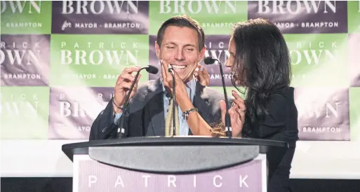  ?? CHRIS YOUNG THE CANADIAN PRESS ?? Patrick Brown celebrates with his wife, Genevieve Gualtieri, after winning the Brampton mayoral race during an election-night rally in Brampton on Oct. 22.