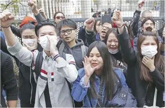  ??  ?? PARIS: Demonstrat­ors from the Asian community protest outside Paris’ 19th district’s police station yesterday. Violent clashes in Paris between baton-wielding police and protesters outraged at the police killing of a Chinese man in his home have seen...