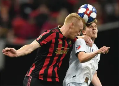  ?? JOHN AMIS ?? FILE - In this Oct. 19, 2019, file photo, Atlanta United defender Jeff Larentowic­z, left, and New England Revolution midfielder Scott Caldwell battle for a header during round one of an MLS Cup playoff soccer game in Atlanta. Atlanta United veteran defender Jeff Larentowic­z, who serves as an executive board member for the players union, said Thursday, June 4, 2020, he has safety concerns about an agreement announced Wednesday for a MLS tournament in Orlando in July. He is worried about the ongoing coronaviru­s pandemic and said “We play a contact sport and the virus is a serious thing that puts us all in danger.”