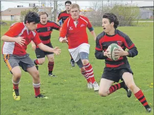  ?? CAPE BRETON POST PHOTO ?? Brett Strong of the Glace Bay High School Panthers rugby team carries the ball past several Riverview High School Rugrats defenders during the Cape Breton Highland High School Rugby League championsh­ip match at the Membertou Athletic Field on...