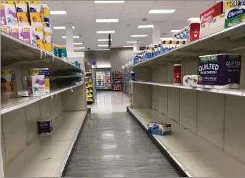  ??  ?? Empty supermarke­t shelves in Massachuse­tts, United States, as coronaviru­s panic buying appears to have created an internatio­nal rush for toilet paper