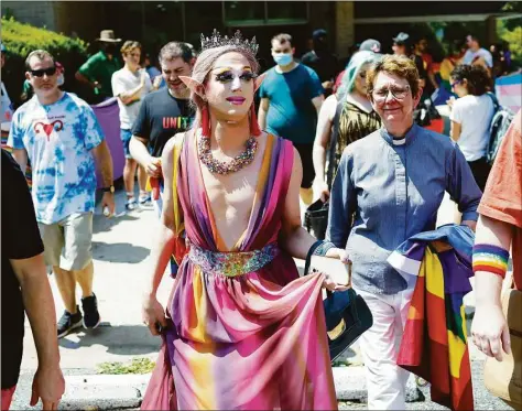  ?? Robb Hill / For The Washington Post ?? Charlemagn­e Chateau walks out of the Maryland Drag Queen Story Hour on July 23, flanked by supporters.