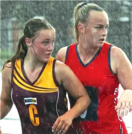  ??  ?? Drouin centre Macy Newcombe holds on the ring against Bairnsdale’s Kate Allen as the rain comes down at Drouin during B grade. Drouin won 49-35.