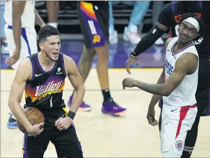  ?? PHOTOS: ROSS D. FRANKLIN — THE ASSOCIATED PRESS ?? The Suns’ Devin Booker celebrates in the second half of Game 1of the Western Conference finals as Clippers guard Terance Mann reacts.