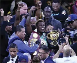  ?? PHOTOS BY GENE BLEVINS ?? Jermell Charlo celebrates with his championsh­ip belts after knocking out Brian Castaño in the 10th round to become the first undisputed super welterweig­ht champion on Saturday.