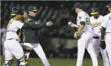  ?? Ben Margot / Associated Press ?? A’s pitcher Andrew Triggs is taken out by manager Bob Melvin after giving up a bases-loaded triple in sixth inning.