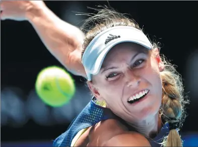  ?? VINCENT THIAN / AP ?? Denmark’s Caroline Wozniacki eyes the ball during her Australian Open semifinal victory over Belgium's Elise Mertens on Thursday. Second seed Wozniacki advanced to the Melbourne final for the first time with a 6-3, 7-6 (2) triumph.