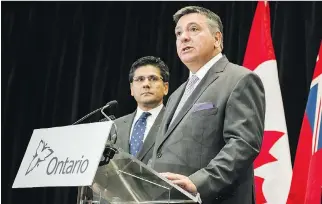  ?? CHRISTOPHE­R KATSAROV/THE CANADIAN PRESS FILES ?? Ontario Finance Minister Charles Sousa, centre, told municipal leaders in a letter last week that the rollout of legal marijuana shops next summer aims to achieve the right geographic distributi­on across the province and to reduce the number of illegal...