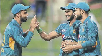  ?? AFP ?? Shadab Khan (left) and Hasan Ali (centre) celebrate the wicket of an Australia batsman in Wednesday’s T20.