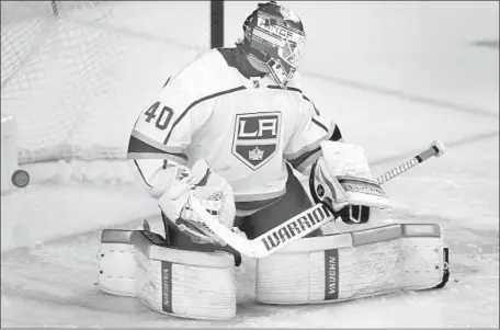  ?? Larry MacDougal Associated Press ?? KINGS GOALIE Cal Petersen watches Mikael Backlund’s goal get past him early in the first period. The goalie stopped the next 28 shots.