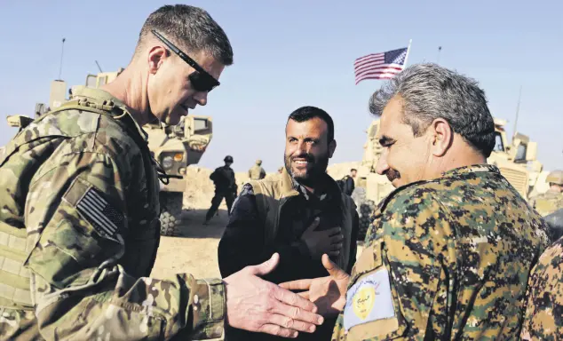  ??  ?? U.S. General Jamie Jarrard (L) thanks a YPG commander near the town of Manbij, northern Syria, Feb. 7, 2018.