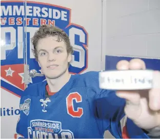  ?? JASON MALLOY/SALTWIRE NETWORK ?? Summerside Western Capitals’ captain Brodie MacArthur holds up the puck he broke the Maritime Junior Hockey League record with during Thursday’s home game at Credit Union Place.