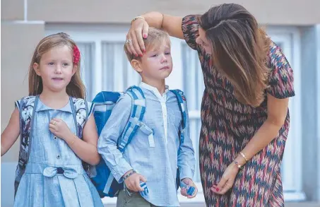  ??  ?? Crown Princess Mary consoles Prince Vincent as he and his sister Princess Josephine, along with dad Crown Prince Frederik, leave for their first day of school. Pictures: MEGA\TheMegaAge­ncy.com, AFP