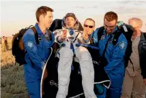  ?? REUTERS ?? Ground crew carry Internatio­nal Space Station crew member Thomas Pesquet of France from the Soyuz capsule after he and Russian cosmonaut Oleg Novitskiy landed in a remote area of Kazakhstan.