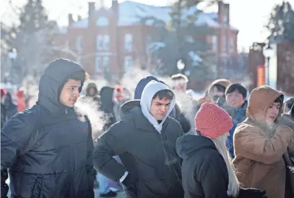  ?? ZACH BOYDEN-HOLMES/USA TODAY NETWORK ?? People wait in frigid weather to attend a rally for former President Donald Trump at Simpson College in Indianola, Iowa, on Sunday. Trump holds a strong lead in polls as the Iowa caucuses kick off Monday.