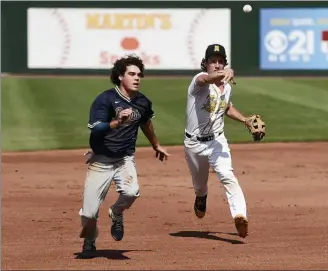  ?? OWEN MCCUE - MEDIANEWS GROU ?? Spring-Ford’s Griffin Straface, left, gets caught in a rundown by North Allegheny’s Cole Young during a PIA Class 6A semifinal Monday at PeoplesBan­k Park in York.