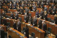  ?? — AFP ?? Members of Parliament observe a minute’s silence as they pay their respects for the victims of the school shooting.