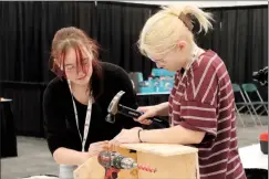  ?? HERALD PHOTO BY ALEJANDRA PULIDO-GUZMAN ?? Who BILDs it Best team LCI-Coalhurst’s Emily Watson and Kyran Ouellette work on their tool box during the compeition at the Home,Garden and Leisure Show.