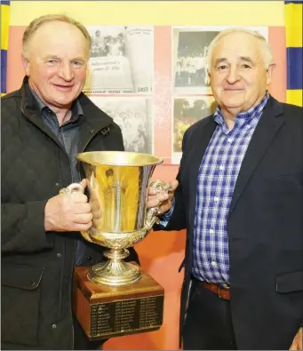  ??  ?? Brother Brothers Tadhg and Eamonn Kelly proudly holding the coveted trophy that they helped bring back to Ballydesmo­nd.