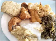  ?? Arkansas Democrat-Gazette/ERIC E. HARRISON ?? A Friday “Meat &amp; Three” cafeteria-style plate lunch at Cathead’s Diner included fried catfish, green beans with bits of barbeued pork, macaroni and cheese, mashed potatoes with cream gravy and a cathead biscuit.