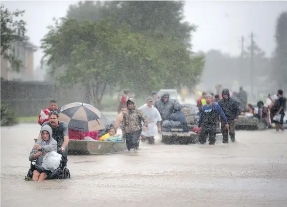  ?? — GETTY IMAGES ?? People are rescued from a flooded neighbourh­ood after it was inundated with rain water, remnants of Hurricane Harvey, on Monday in Houston. The storm is expected to dump upwards of 50 centimetre­s of rain in areas of Texas over the next couple of days.