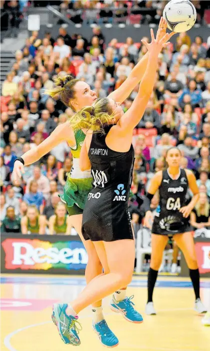  ?? Photo / Photosport ?? Silver Ferns wing attack Gina Crampton vies for the ball with South Africa’s Shadine van der Merwe.