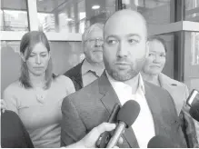  ??  ?? Tyler Madill, the brother of the victim, speaks to reporters Tuesday as other members of the Madill family look on.