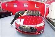 ??  ?? In this file photo, a worker cleans a Tesla Model S sedan before an event to deliver the first set of cars to customers in Beijing. Electric auto brandTesla Inc says Wednesday, Oct 17, it has secured land in Shanghai for its firstfacto­ry outside the United States, pushing ahead despite mounting US-Chinesetra­de tensions. (AP)