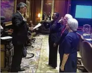  ?? BILL RANKIN / BRANKIN@AJC.COM ?? Georgia Supreme Court Justice Michael Boggs (left) swears in new JQC board members Friday in Atlanta: Bibb County Superior Court Judge Verda Colvin (center) and ex-U.S. Rep. Bob Barr, who is with his wife, Jeri.