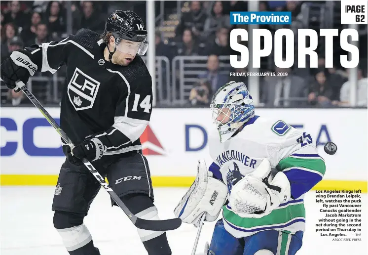  ?? —THE ASSOCIATED PRESS ?? Los Angeles Kings left wing Brendan Leipsic, left, watches the puck fly past Vancouver Canucks goaltender Jacob Markstrom without going in the net during the second period on Thursday in Los Angeles.