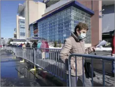  ?? AP PHOTO/STEVEN SENNE ?? People enter a socially distanced line to get their COVID-19 vaccinatio­ns at Gillette Stadium, Monday in Foxborough, Mass.