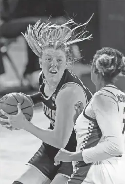  ??  ?? Iowa forward Monika Czinano drives against Kentucky forward Keke McKinney on Tuesday.