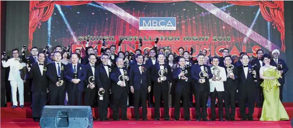  ??  ?? One for the album: Chua (seventh from right) and Saifuddin (seventh from left) posing for a photo with past presidents, advisers, corporate patrons, council members and guests at the MRCA Council Installati­on Night 2018 event at One World Hotel in Petaling Jaya.