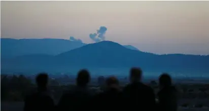  ?? (Osman Orsal/Reuters) ?? SMOKE RISES from Syria’s northern Afrin region this week, as seen from near the Turkish town of Hassa, on the country’s border.