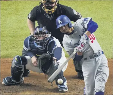  ?? SUE OGROCKI — THE ASSOCIATED PRESS ?? The Dodgers’ Mookie Betts smacks an RBI single against the Rays during the fourth inning in Game 3 of the World Series on Oct. 23 in Arlington, Texas.