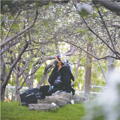  ?? ALLEN MCINNIS ?? A woman sits in the shade of trees at the Canadian Centre for Architectu­re on Saturday.