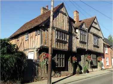  ??  ?? ABOVE: The 14th century De Vere House, Lavenham, will be familiar to Harry Potter fans. BELOW: The magnificen­t mummified moggy in Bury’s diminutive Nutshell pub; according to locals the cat has a curse attached to it.