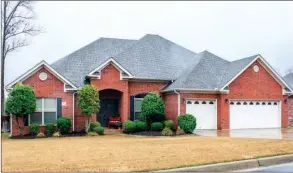  ?? PHOTOS BY LINDA GARNER-BUNCH/Arkansas Democrat-Gazette ?? Exquisite landscapin­g adds to the curb appeal of this four-bedroom, three-bath home. The   owing   oor plan offers formal and casual living spaces, as well as a screened porch.