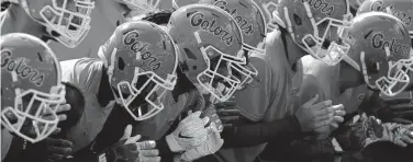  ?? JOHN RAOUX AP ?? Florida players warm up before an NCAA college football game against LSU in 2018, in Gainesvill­e.