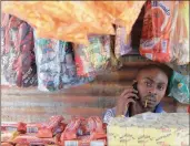  ?? PHOTO: BLOOMBERG ?? A street vendors sells sell prepaid Vodacom airtime in Alexandra, South Africa.