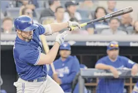  ?? Bill Kostroun / Associated Press ?? Toronto’s Randal Grichuk hits a double during the seventh inning on Saturday. The Blue Jays nearly squandered a seven-run lead.