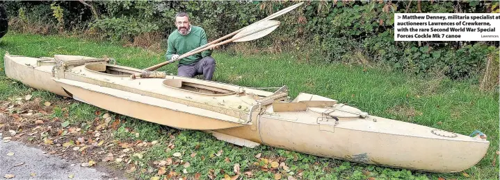  ?? Lawrences ?? > Matthew Denney, militaria specialist at auctioneer­s Lawrences of Crewkerne, with the rare Second World War Special Forces Cockle Mk 7 canoe