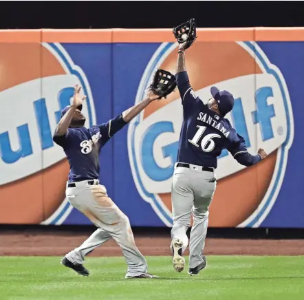  ?? AP ?? Lorenzo Cain (left), who returned to the Brewers’ lineup Friday night, is on a collision course with Domingo Santana.